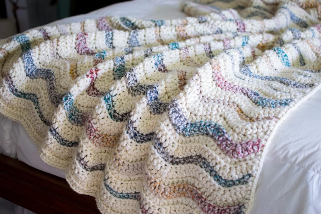 Free crochet blanket pattern with ribbed ripple stitch in cream and metallic gold