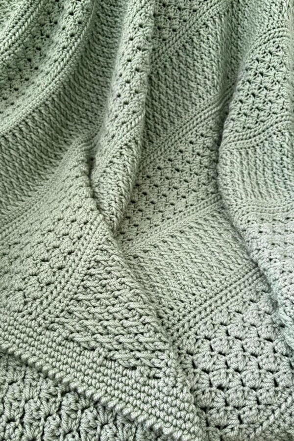 Textured crochet throw pattern featuring Alpine and Sedge stitches in solid color