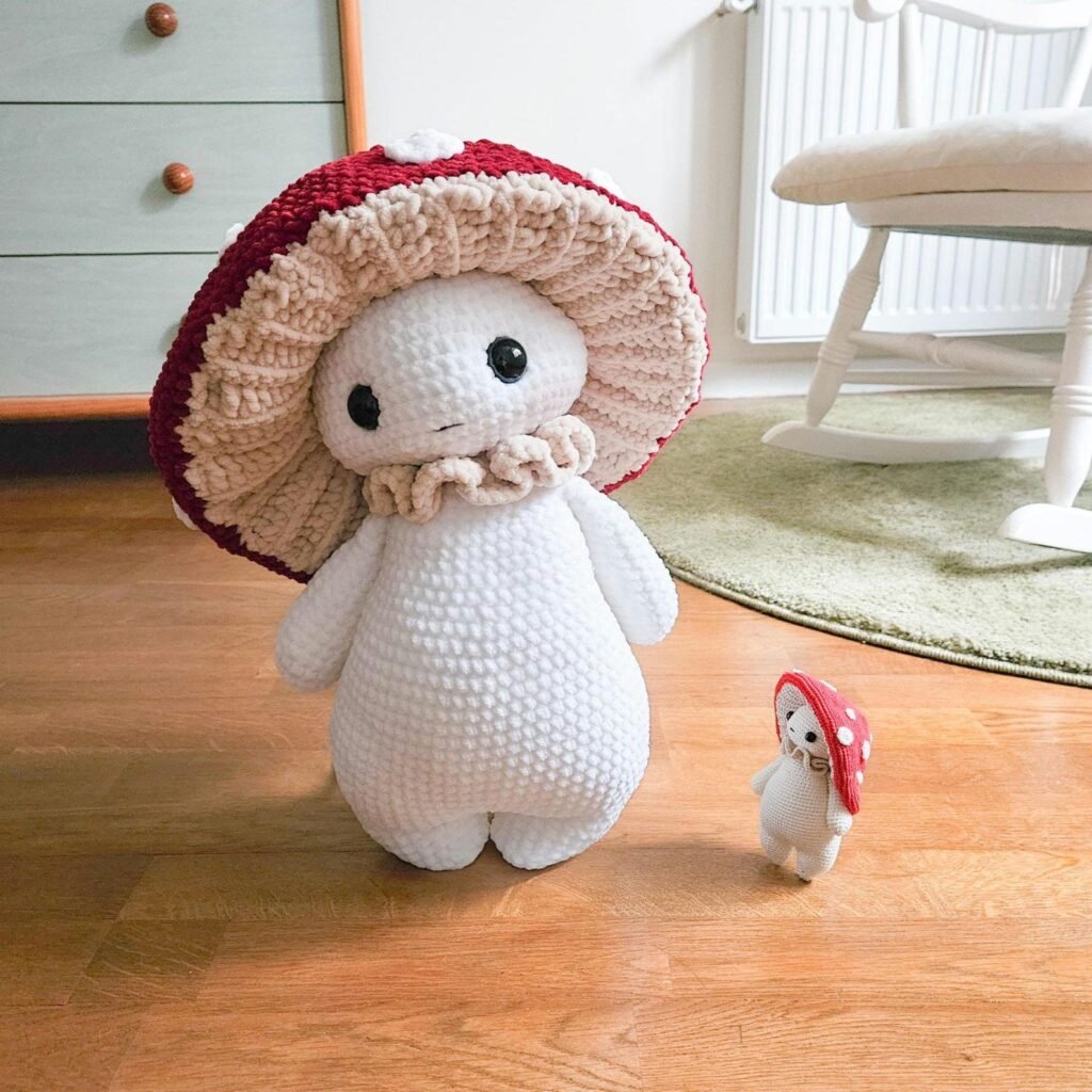 Free mushroom crochet pattern showing adorable amigurumi creature with safety eyes