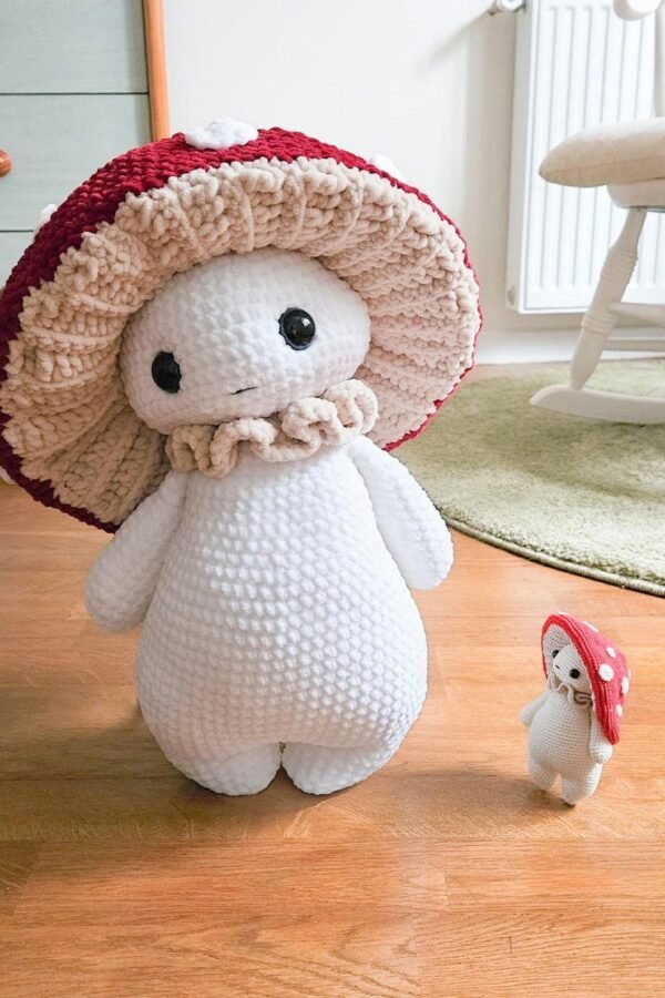 Free mushroom crochet pattern showing adorable amigurumi creature with safety eyes